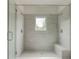 Glass-enclosed shower with a built-in bench, dual shower heads, and a window at 2029 Memorial Dr # 34, Atlanta, GA 30317