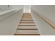 Elegant staircase with wooden treads and white risers leading to a door at 2029 Memorial Dr # 34, Atlanta, GA 30317