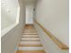 Bright white staircase with wood railing and treads leading to upper level at 2029 Memorial Dr # 34, Atlanta, GA 30317