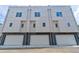 Street view of newly built townhomes with gray and white exteriors, featuring attached garages at 2029 Memorial Dr # 34, Atlanta, GA 30317