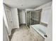 Bathroom featuring a soaking tub with tile surround and a glass-enclosed shower at 3650 Lindsy Brooke Ct, Douglasville, GA 30135