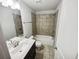 This bathroom features tile flooring, a bathtub, and a well-lit vanity area at 3650 Lindsy Brooke Ct, Douglasville, GA 30135