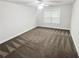 Empty bedroom features neutral walls, and carpeted floors, offering a blank canvas for personalization at 3650 Lindsy Brooke Ct, Douglasville, GA 30135