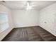 Cozy bedroom with neutral carpet, ceiling fan, window, and closet with double doors at 3650 Lindsy Brooke Ct, Douglasville, GA 30135
