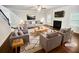This is a bright living room with a fireplace, a ceiling fan, and stairs leading to the upper floor at 3650 Lindsy Brooke Ct, Douglasville, GA 30135