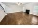 Spacious living room with hardwood floors, a fireplace, a ceiling fan, and stairs leading to the upper floor at 3650 Lindsy Brooke Ct, Douglasville, GA 30135
