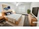 This staged main bedroom has neutral decor, a ceiling fan, and a large window that provides lots of natural light at 3650 Lindsy Brooke Ct, Douglasville, GA 30135