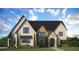 Inviting two-story home with a brick facade, detailed trim, and a lush green lawn at 2013 Old Atlanta Rd, Cumming, GA 30041