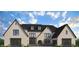 Charming two-story home with a brick facade, detailed trim, and a landscaped yard at 2013 Old Atlanta Rd, Cumming, GA 30041