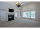Bright bedroom with fireplace, built-in shelving, and large windows offering ample natural light at 858 Middle Fork Trl, Suwanee, GA 30024