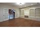 Versatile bonus room with hardwood floors, built-in bookshelves, and French doors at 858 Middle Fork Trl, Suwanee, GA 30024