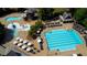 Aerial view of a community pool area featuring a large pool, splash pad, and lounge chairs at 858 Middle Fork Trl, Suwanee, GA 30024