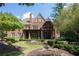 Beautiful brick home with manicured lawn, mature landscaping, and a covered porch at 858 Middle Fork Trl, Suwanee, GA 30024
