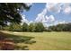 Picturesque golf course view featuring lush green fairways and a sand trap at 858 Middle Fork Trl, Suwanee, GA 30024