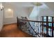 Elegant staircase featuring hardwood floors, iron railings, and a view of the front door with leaded glass at 858 Middle Fork Trl, Suwanee, GA 30024