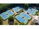 Aerial view of multiple tennis courts in a private community with trees at 858 Middle Fork Trl, Suwanee, GA 30024