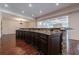 Elegant basement bar with granite countertop and dark wood cabinetry at 3133 Saint Ives Country Club Pkwy, Johns Creek, GA 30097