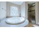 Luxurious bathroom with a large soaking tub, glass shower, and elegant tile at 3133 Saint Ives Country Club Pkwy, Johns Creek, GA 30097