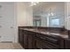 Bathroom with dark brown vanity and granite countertop at 3133 Saint Ives Country Club Pkwy, Johns Creek, GA 30097