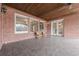 Spacious covered patio with brick columns and wood ceiling at 3133 Saint Ives Country Club Pkwy, Johns Creek, GA 30097