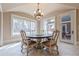 Sunlit dining area with hardwood floors and access to outdoor patio at 3133 Saint Ives Country Club Pkwy, Johns Creek, GA 30097