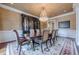 Spacious dining room features a large table, chandelier and a large hutch at 3133 Saint Ives Country Club Pkwy, Johns Creek, GA 30097