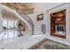 Elegant entryway with grand staircase, marble floors, and views to formal dining room at 3133 Saint Ives Country Club Pkwy, Johns Creek, GA 30097