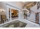 Two-story entryway showcasing a curved staircase, chandelier, and formal dining room view at 3133 Saint Ives Country Club Pkwy, Johns Creek, GA 30097