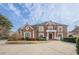 Grand two-story home with brick facade at 3133 Saint Ives Country Club Pkwy, Johns Creek, GA 30097