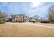 Two-story home with circular driveway and landscaping at 3133 Saint Ives Country Club Pkwy, Johns Creek, GA 30097