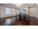 Basement game room with ping pong table, hardwood floors, and large windows at 3133 Saint Ives Country Club Pkwy, Johns Creek, GA 30097