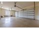 Spacious three-car garage with ample storage space and white garage doors at 3133 Saint Ives Country Club Pkwy, Johns Creek, GA 30097