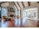 Bright Gathering room with hardwood floors, stone fireplace, and views to backyard at 3133 Saint Ives Country Club Pkwy, Johns Creek, GA 30097