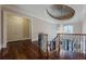 Stunning hallway with hardwood floors, a chandelier, and a view of the grand staircase at 3133 Saint Ives Country Club Pkwy, Johns Creek, GA 30097