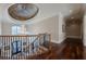 Elegant upper hallway with hardwood floors, chandelier, and dome ceiling at 3133 Saint Ives Country Club Pkwy, Johns Creek, GA 30097