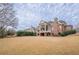 Back of house, brick exterior, large yard at 3133 Saint Ives Country Club Pkwy, Johns Creek, GA 30097