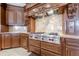 Close-up of a Wolf range and custom cabinetry in a luxury kitchen at 3133 Saint Ives Country Club Pkwy, Johns Creek, GA 30097