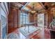 Study with wood paneled walls, hardwood floors, large window and fireplace at 3133 Saint Ives Country Club Pkwy, Johns Creek, GA 30097