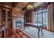 Elegant library with wood walls, fireplace, large window, and hardwood floors at 3133 Saint Ives Country Club Pkwy, Johns Creek, GA 30097