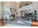 Living room features hardwood floors, fireplace, large windows, and a grand piano at 3133 Saint Ives Country Club Pkwy, Johns Creek, GA 30097