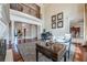 Spacious living room with hardwood floors, views to entry and kitchen, and a grand piano at 3133 Saint Ives Country Club Pkwy, Johns Creek, GA 30097