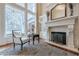 Living room boasts a fireplace, built-in shelving, hardwood floors and large windows at 3133 Saint Ives Country Club Pkwy, Johns Creek, GA 30097