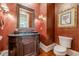 Elegant powder room features dark wood vanity, marble countertop, and rich walls at 3133 Saint Ives Country Club Pkwy, Johns Creek, GA 30097