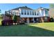 Expansive backyard with lush lawn, patio, and exterior staircase leading to a sunroom at 3240 Somerset Se Ct, Conyers, GA 30013