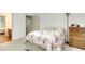 Bedroom featuring neutral carpet with warm floral pattern bedspread and lamp at 3240 Somerset Se Ct, Conyers, GA 30013