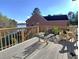 Spacious wooden deck with lake view, featuring chairs for relaxing and enjoying the scenery at 3240 Somerset Se Ct, Conyers, GA 30013