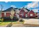 Charming brick home featuring an attached garage, lush landscaping, and a welcoming driveway at 3240 Somerset Se Ct, Conyers, GA 30013