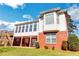 Beautiful two-story home features a sunroom, brick facade, manicured lawn, and basement access at 3240 Somerset Se Ct, Conyers, GA 30013
