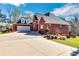 Stately brick home with a three-car garage, manicured landscaping, and long driveway at 3240 Somerset Se Ct, Conyers, GA 30013