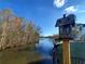 Scenic lake view with mature trees and a decorative birdhouse in a peaceful setting at 3240 Somerset Se Ct, Conyers, GA 30013
